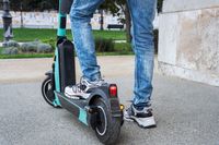 person-using-electric-scooter-city